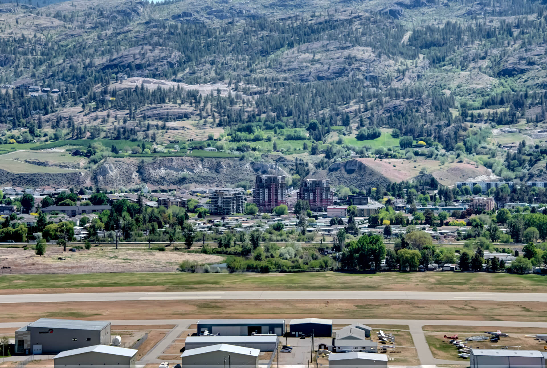 View of Penticton hillside, with condo towers in center of image.